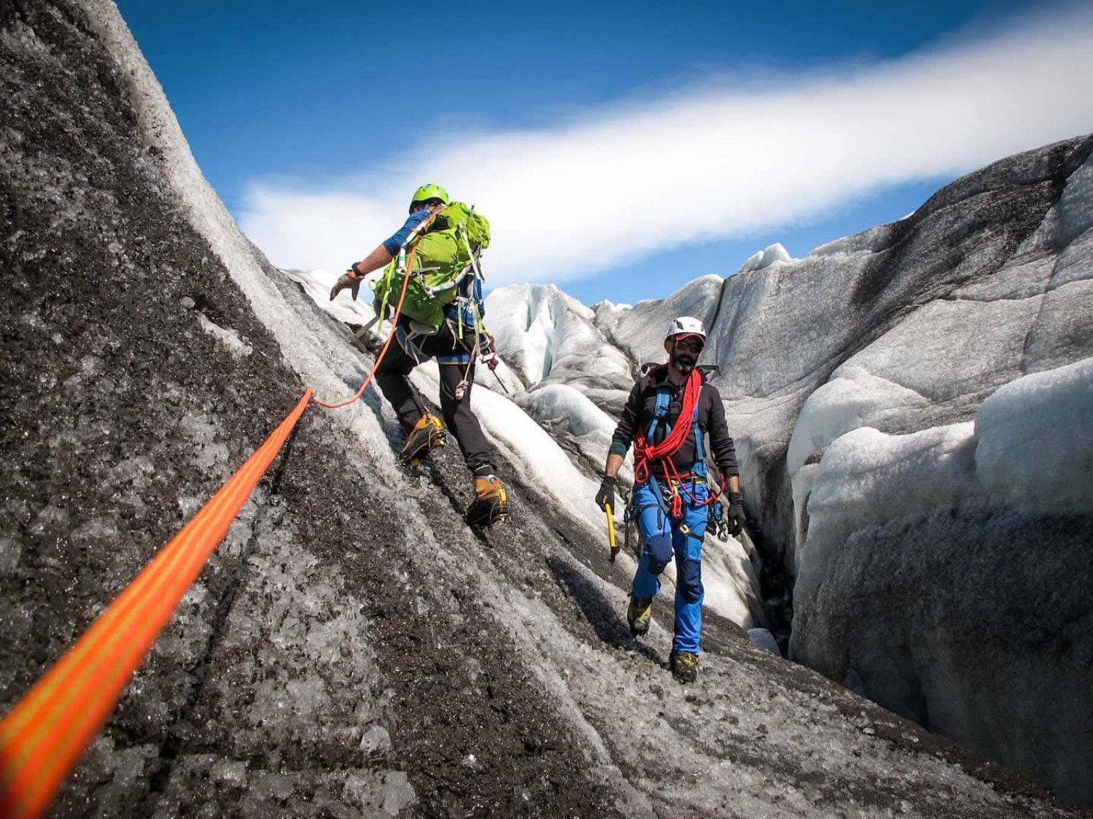 Glacier guides moving through dramatic Icelandic ice terrain